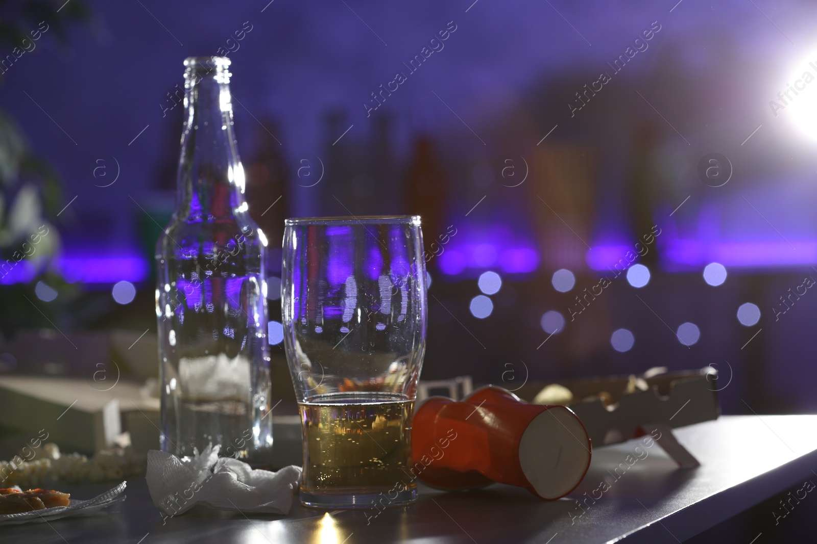 Photo of Messy table with beer and food leftovers indoors, space for text. After party chaos