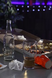 Photo of Messy table with beer and food leftovers indoors. After party chaos
