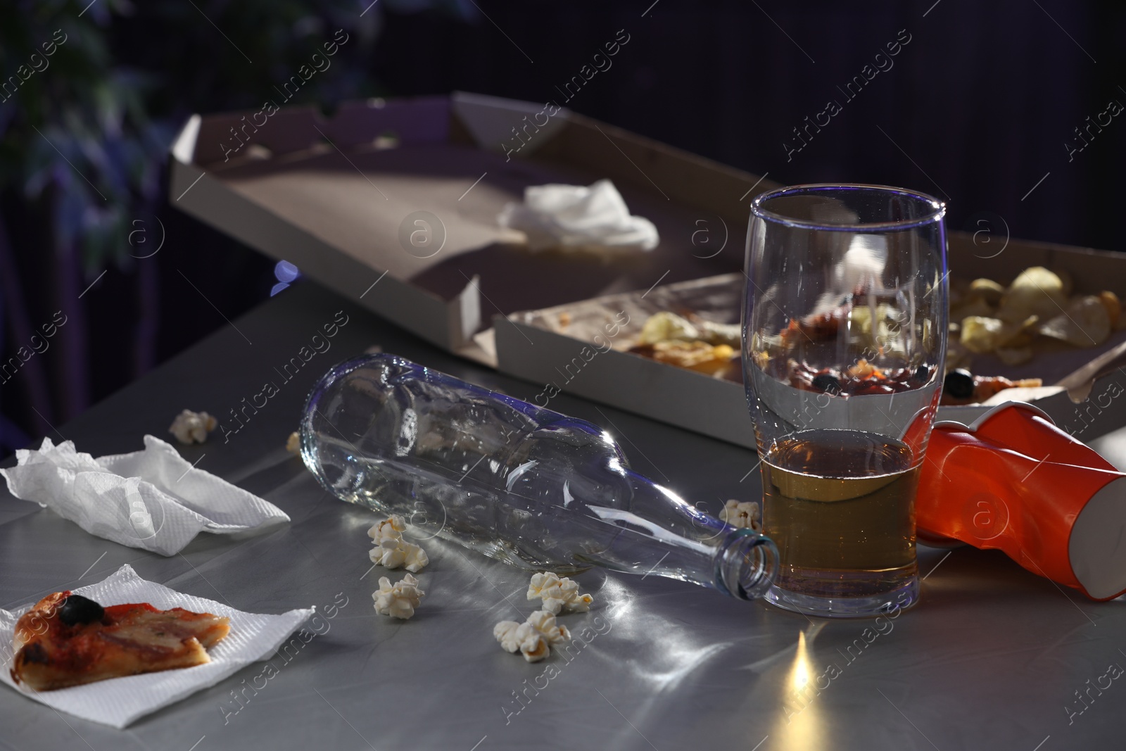 Photo of Messy table with beer and food leftovers indoors. After party chaos