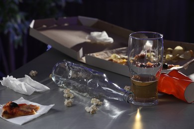 Photo of Messy table with beer and food leftovers indoors. After party chaos