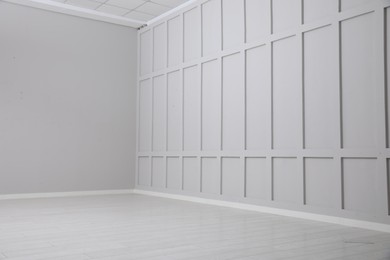 Photo of Empty spacious room with white wooden floor and walls