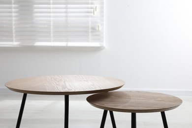 Photo of Empty wooden nesting tables indoors. Stylish furniture