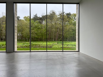 Photo of Empty room with panoramic windows and grey floor