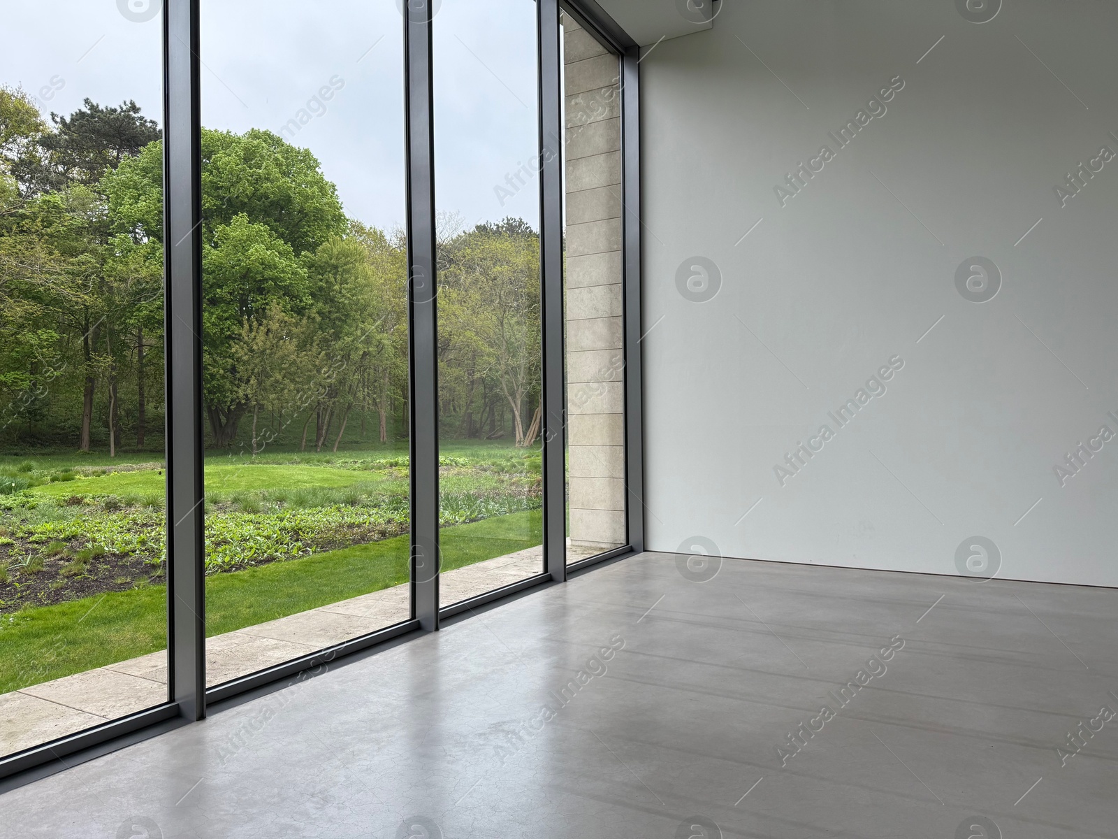 Photo of Empty room with panoramic windows and grey floor