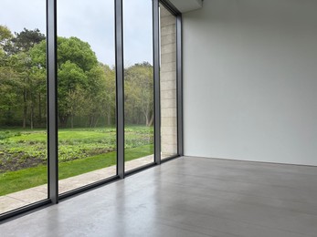 Photo of Empty room with panoramic windows and grey floor