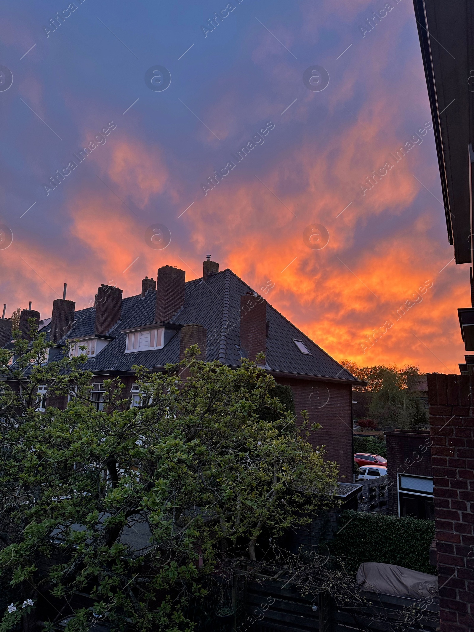 Photo of View of residential building against beautiful sky on sunset