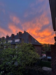 Photo of View of residential building against beautiful sky on sunset