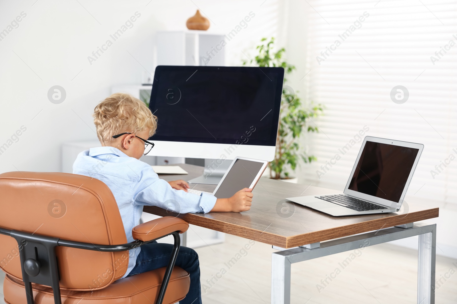 Choice of profession. Little boy pretending to work in office Photo of Choice of profession. Little boy pretending to work in office