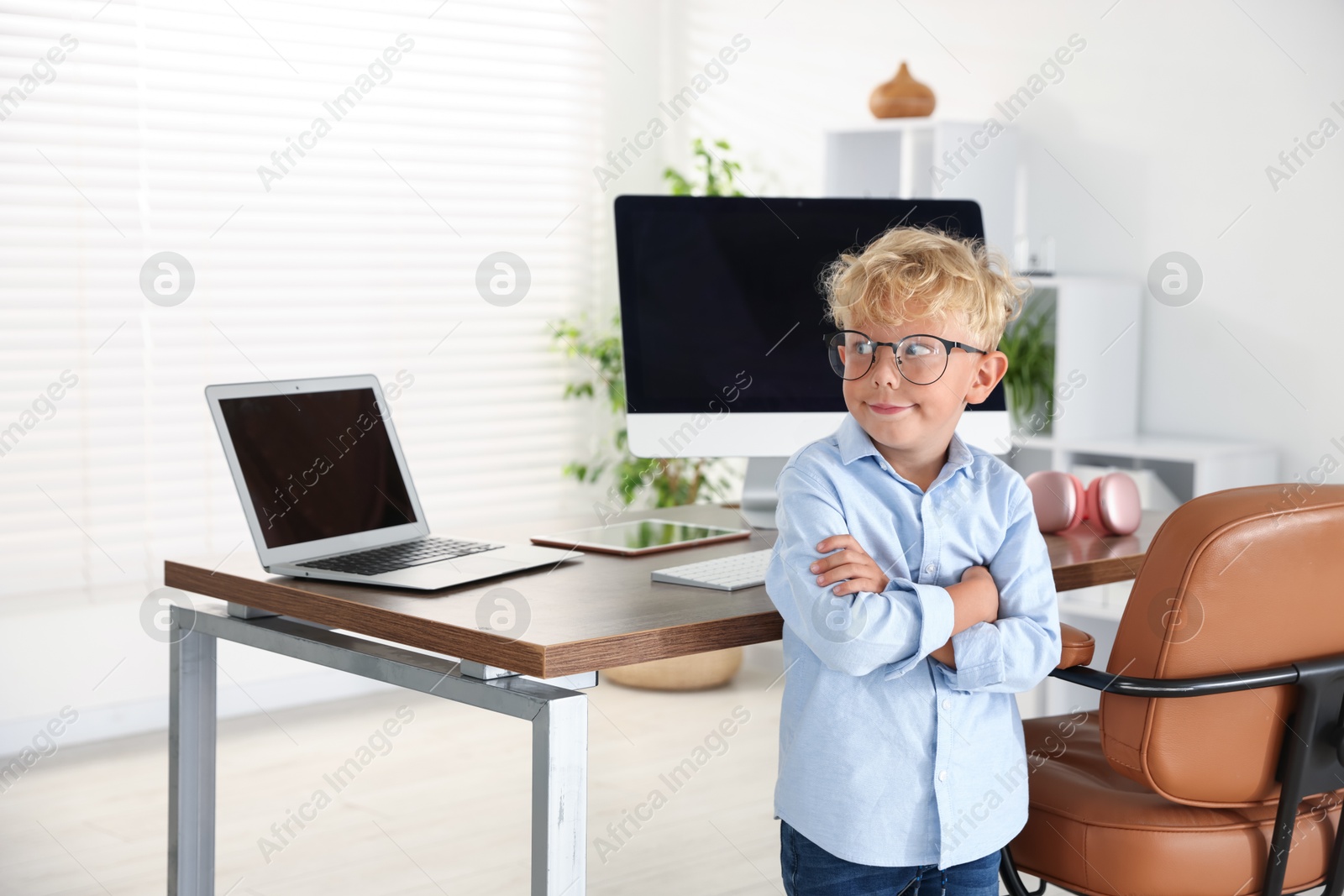 Photo of Choice of profession. Little boy pretending to work in office