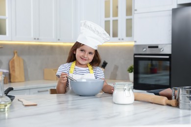 Photo of Choice of profession. Little girl pretending to be chef in kitchen