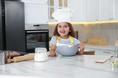 Photo of Choice of profession. Little girl pretending to be chef in kitchen