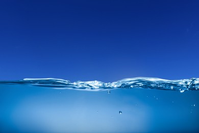 Image of Sea water surface and underwater view. Blue sky above