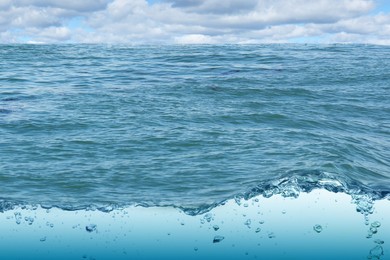 Image of Sea water surface and underwater view. Sky with clouds above