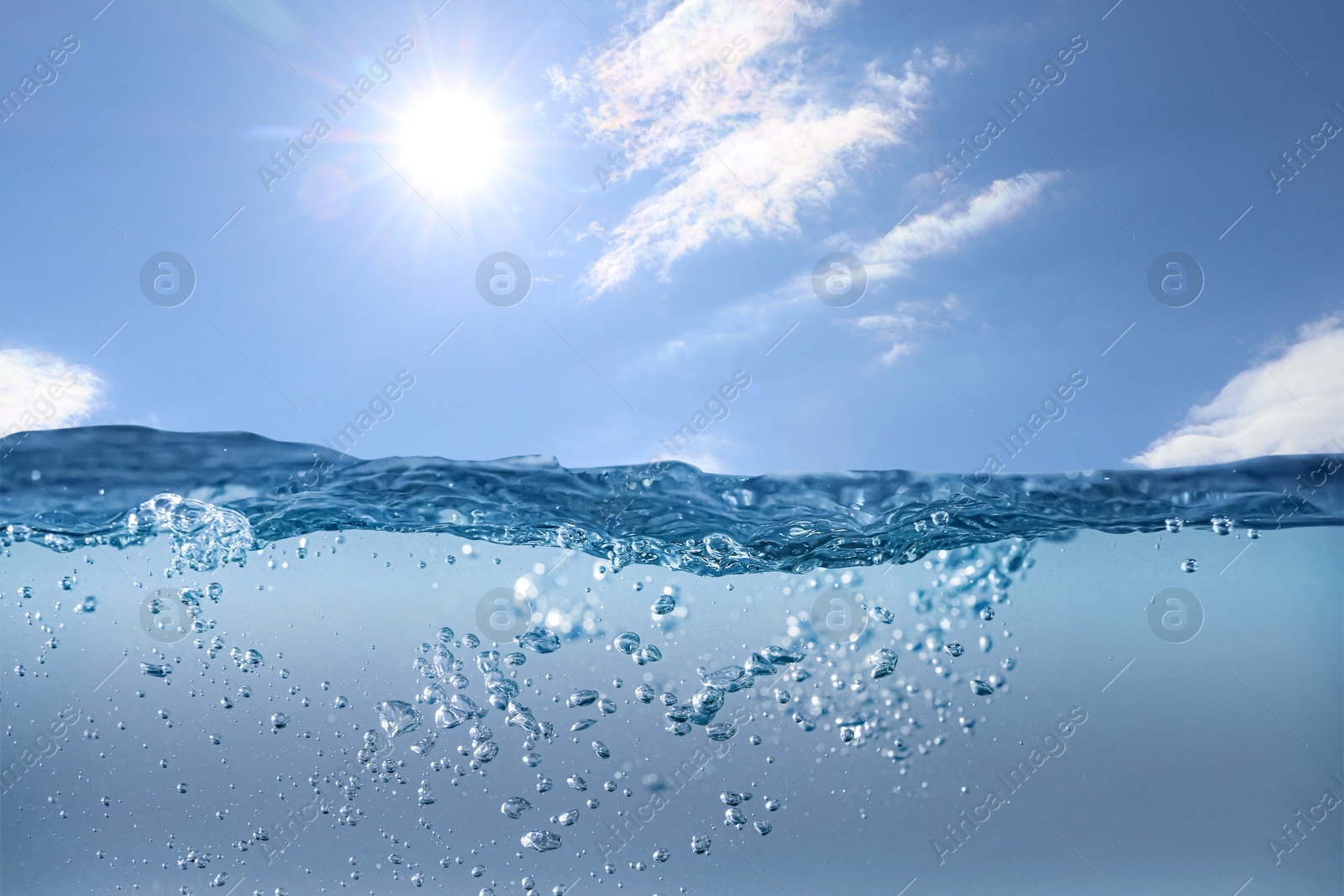 Image of Sea water surface and underwater view. Sky with clouds above