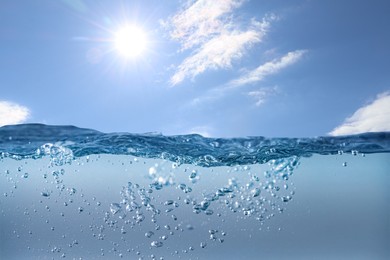 Image of Sea water surface and underwater view. Sky with clouds above