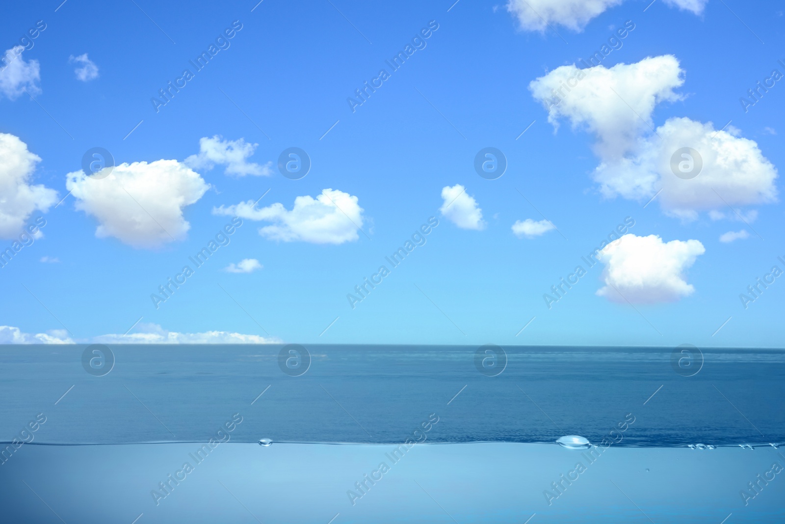 Image of Sea water surface and underwater view. Sky with clouds above