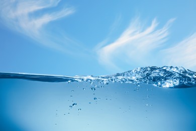 Image of Sea water surface and underwater view. Sky with clouds above