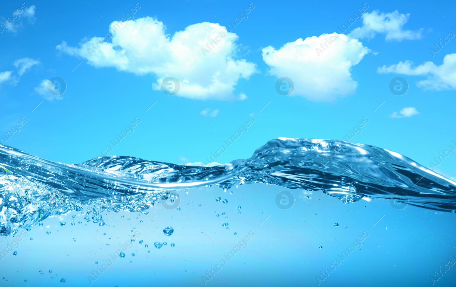 Image of Sea water surface and underwater view. Sky with clouds above