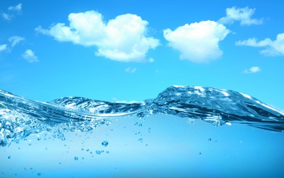 Image of Sea water surface and underwater view. Sky with clouds above