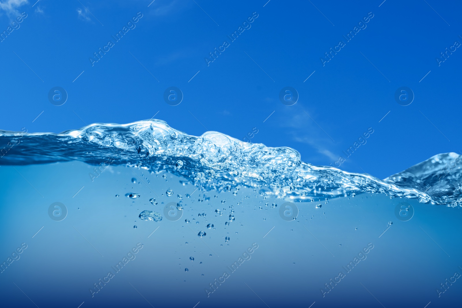 Image of Sea water surface and underwater view. Blue sky above