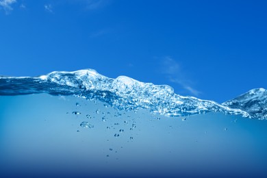 Image of Sea water surface and underwater view. Blue sky above