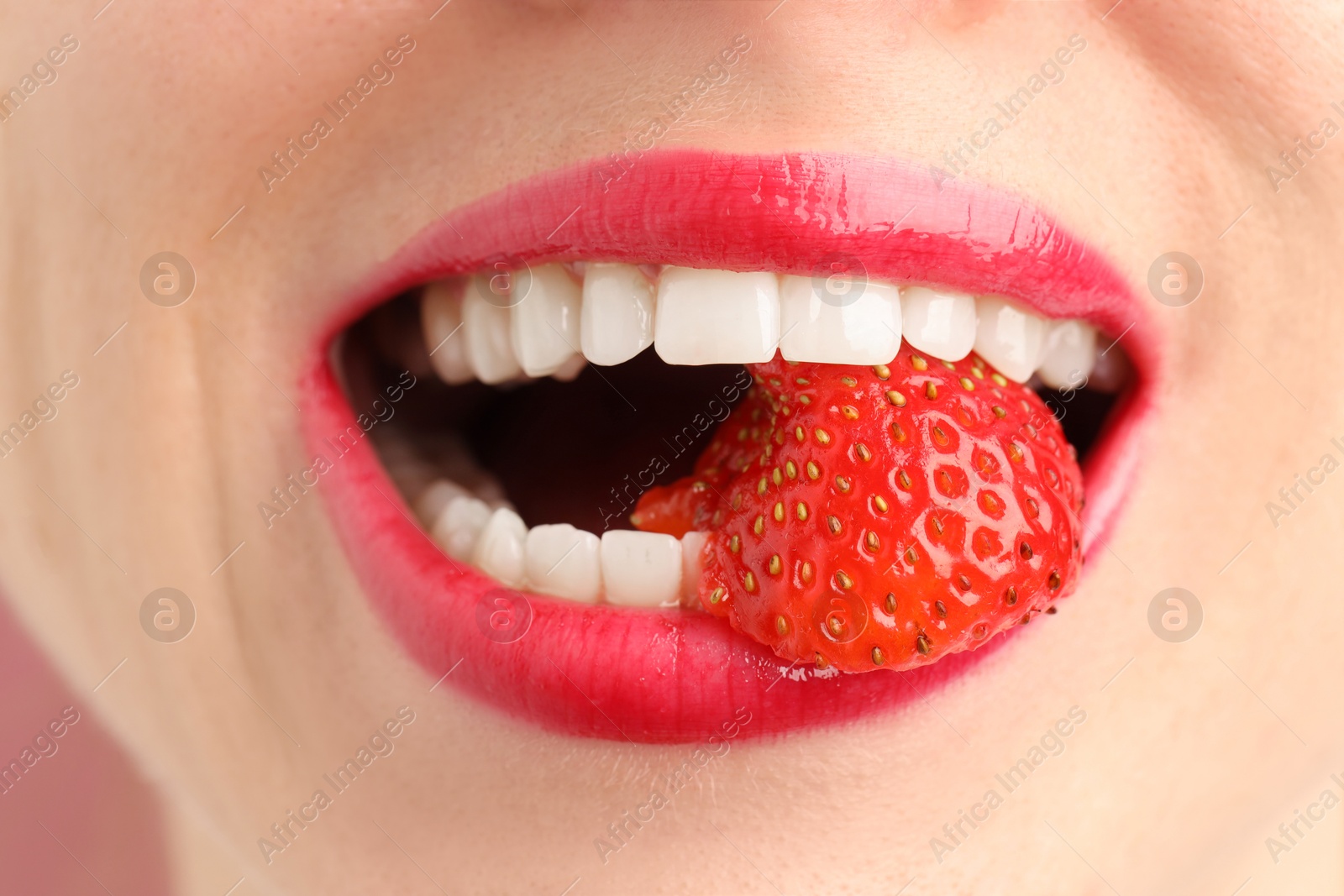Woman with beautiful lips makeup and strawberry, closeup Photo of Woman with beautiful lips makeup and strawberry, closeup