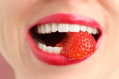 Photo of Woman with beautiful lips makeup and strawberry, closeup