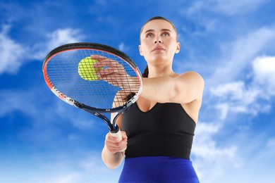 Image of Woman playing tennis against blue sky with clouds, low angle view