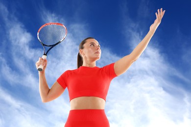 Image of Woman playing tennis against blue sky with clouds, low angle view