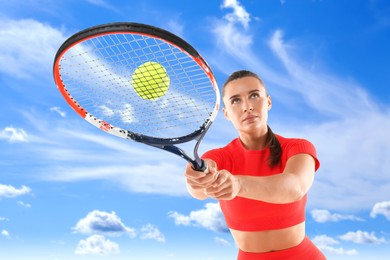 Image of Woman playing tennis against blue sky with clouds, low angle view