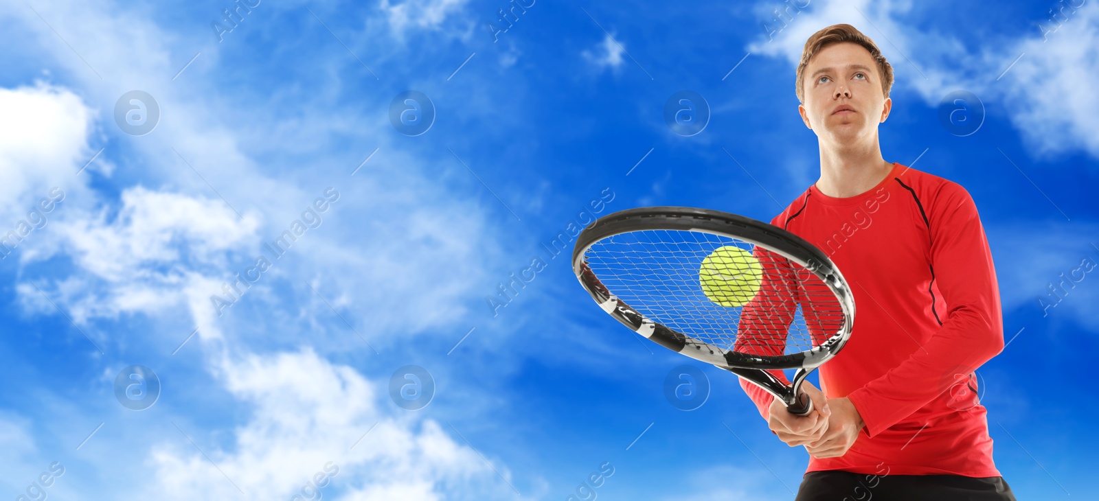 Image of Man playing tennis against blue sky with clouds, low angle view. Banner design