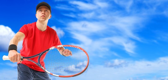 Image of Man playing tennis against blue sky with clouds, low angle view. Banner design