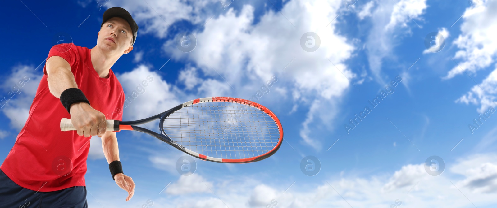 Image of Man playing tennis against blue sky with clouds, low angle view. Banner design