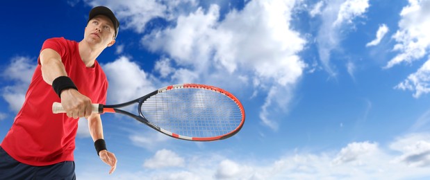 Image of Man playing tennis against blue sky with clouds, low angle view. Banner design