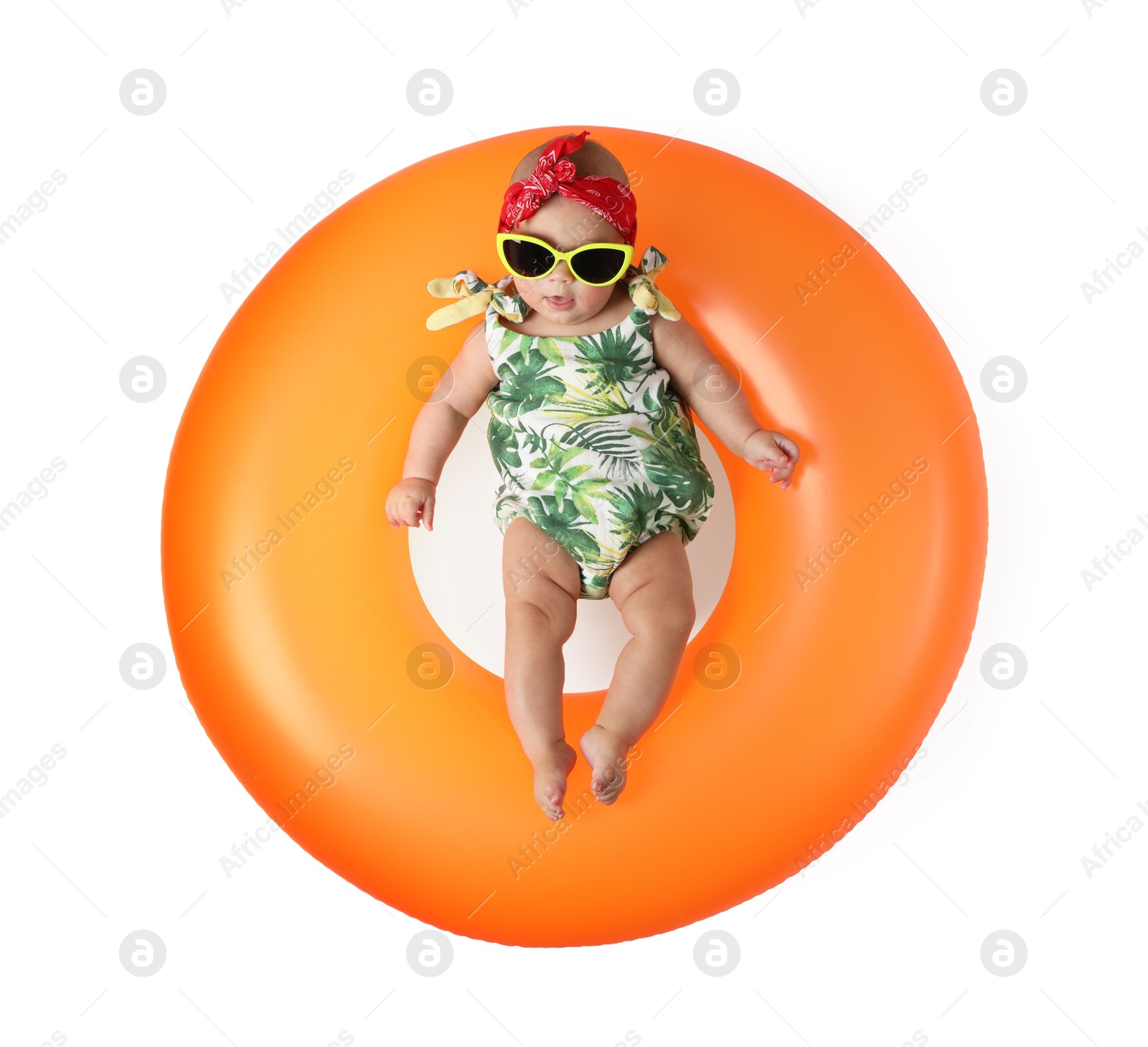 Photo of Cute little baby in sunglasses with inflatable ring on white background, top view