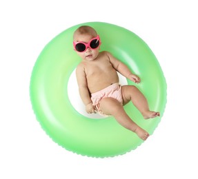 Photo of Cute little baby in sunglasses with inflatable ring on white background, top view