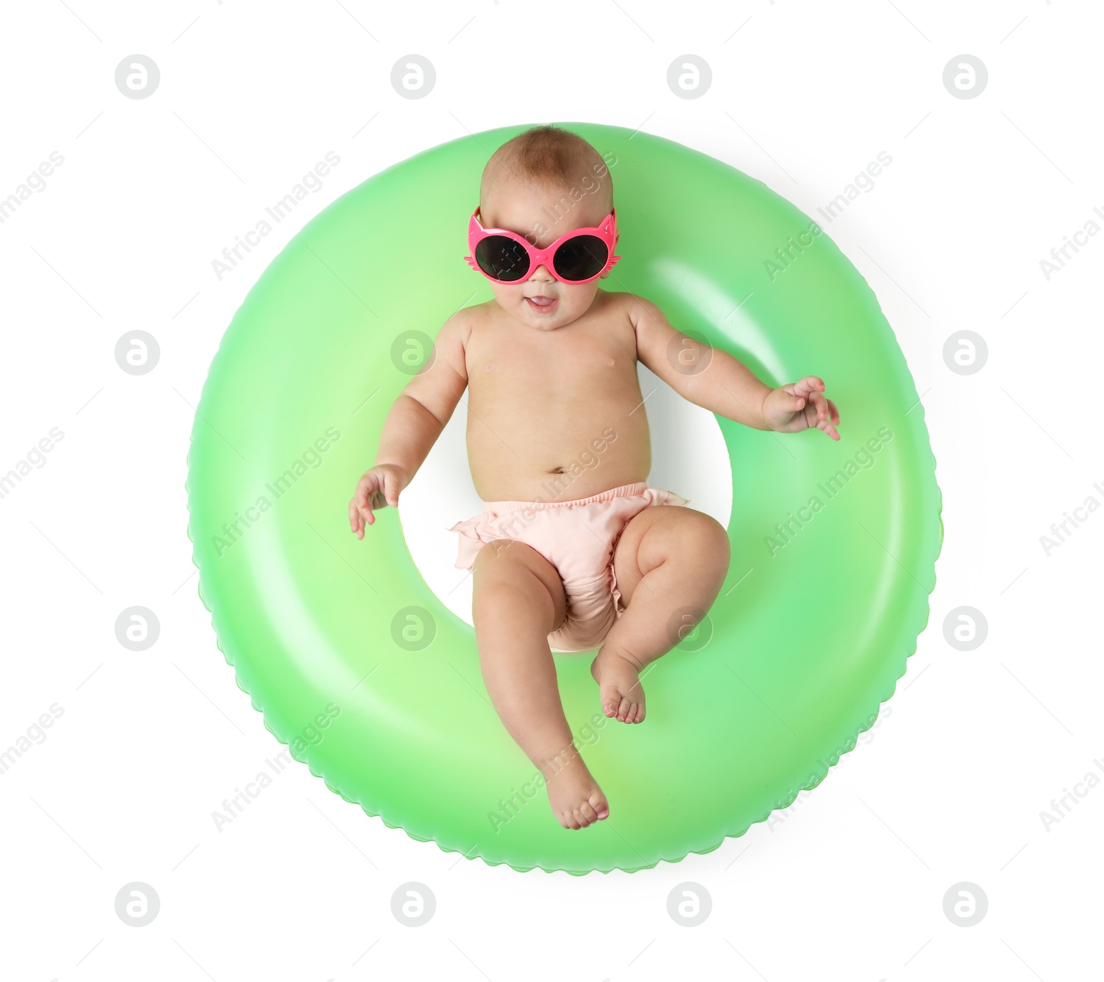 Photo of Cute little baby in sunglasses with inflatable ring on white background, top view