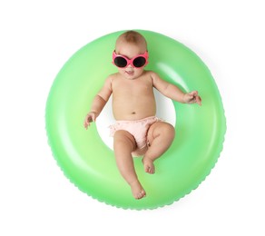 Photo of Cute little baby in sunglasses with inflatable ring on white background, top view
