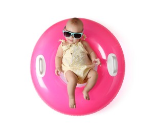 Photo of Cute little baby in sunglasses with inflatable ring on white background, top view