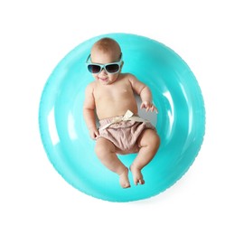 Photo of Cute little baby in sunglasses with inflatable ring on white background, top view