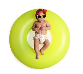 Photo of Cute little baby in sunglasses with inflatable ring on white background, top view