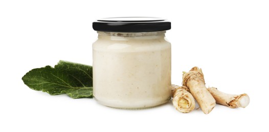 Photo of Tasty horseradish sauce in glass jar, leaf and roots isolated on white