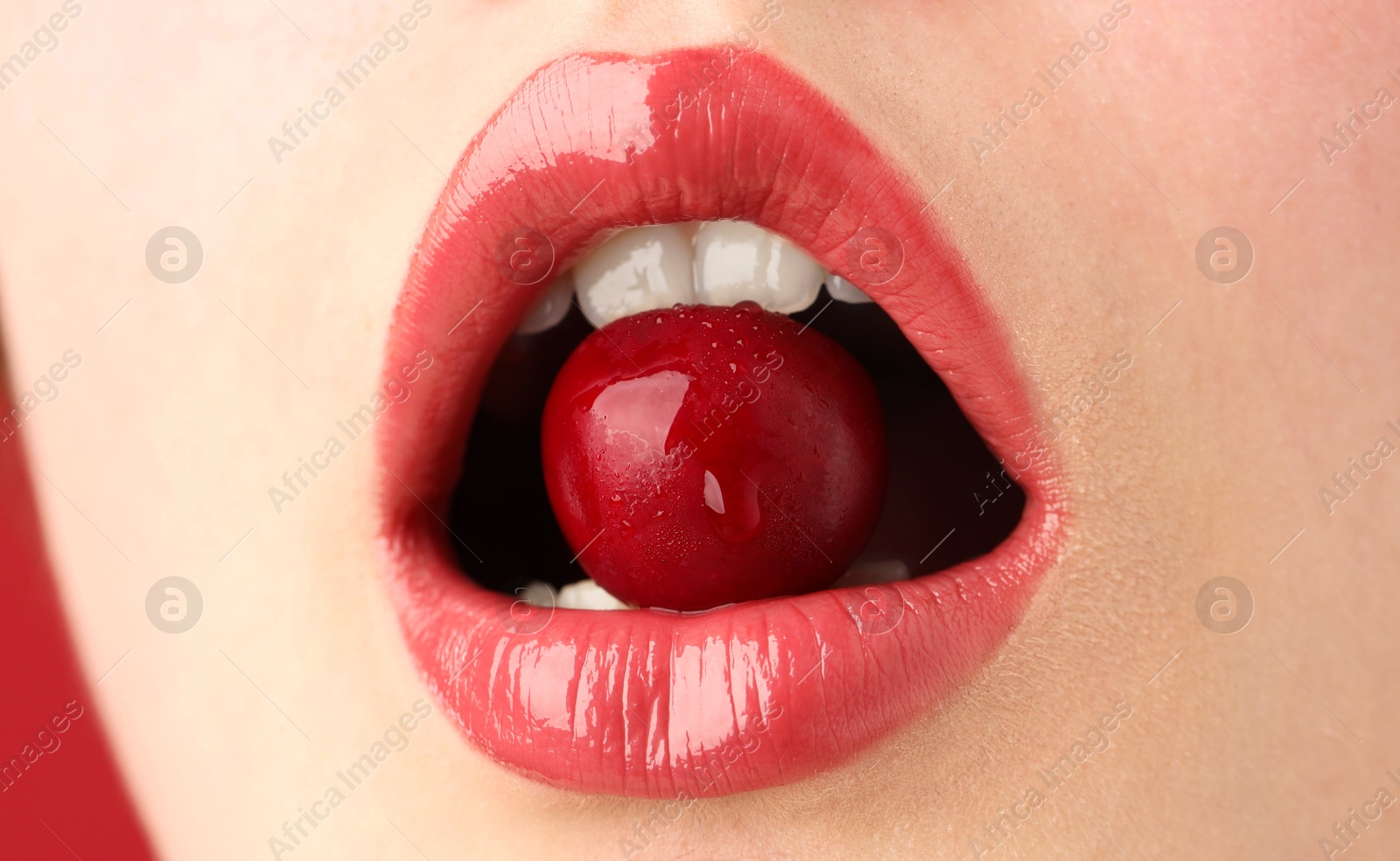 Photo of Woman with beautiful lips makeup and cherry, closeup