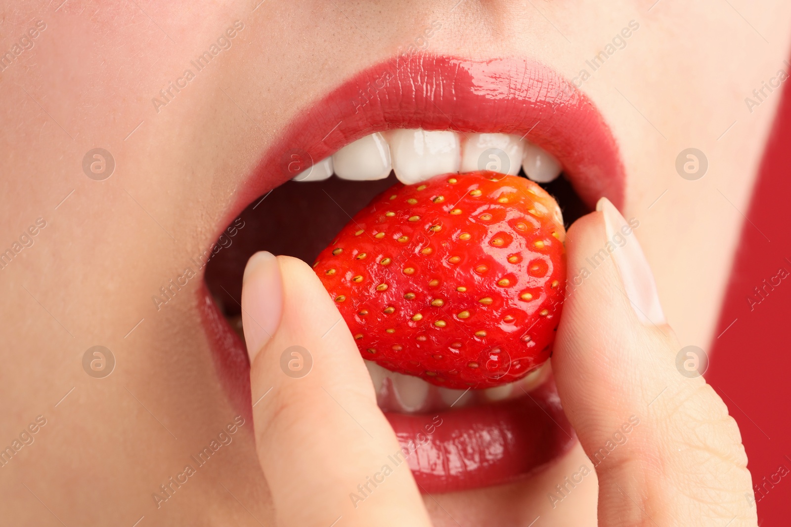 Photo of Woman with beautiful lips makeup and strawberry, closeup