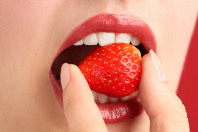 Photo of Woman with beautiful lips makeup and strawberry, closeup