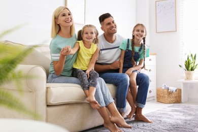 Photo of Happy family with children on sofa indoors