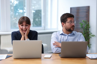 Photo of Man feeling jealous of his colleague's success in office