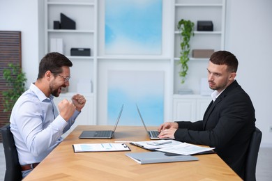 Photo of Man feeling jealous of his colleague's success in office