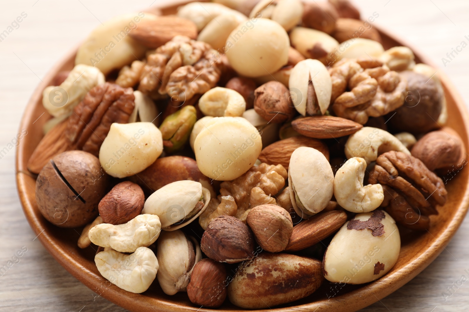 Mix of different nuts on wooden table, closeup Photo of Mix of different nuts on wooden table, closeup