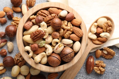 Photo of Mix of different nuts on grey table, flat lay